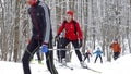 Young skiers assaulting steep hill on thumb track