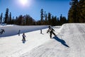 Young kids Ski/Snowboard the mini half-pipe at Mammoth Mountain, California USA