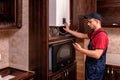 A young skilled worker regulates the gas boiler before use Royalty Free Stock Photo