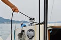 A young skipper girl while working on the sailboat