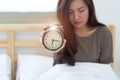 Young sleeping woman and alarm clock Royalty Free Stock Photo