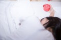 Young sleeping woman and alarm clock in bedroom Royalty Free Stock Photo