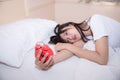 Young sleeping woman and alarm clock in bedroom Royalty Free Stock Photo