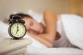 Young sleeping woman in bedroom.