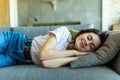 Young sleeping woman is lying on a pillow on a couch Royalty Free Stock Photo