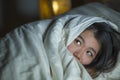 Young sleepless beautiful and scared Asian Chinese woman lying on bed awake at night suffering nightmare after watching zombie Royalty Free Stock Photo