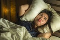 Young sleepless beautiful and scared Asian Japanese woman lying on bed awake at night suffering nightmare after watching zombie Royalty Free Stock Photo