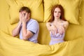 Male living with sleepwalker wife, lying on bed together, frightened Royalty Free Stock Photo