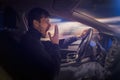 Young sleepy man is yawning and driving car at night. Royalty Free Stock Photo