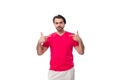 young slender brunette advertiser man dressed in a red t-shirt. corporate color concept