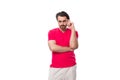 young slender brunette advertiser man dressed in a red t-shirt. corporate color concept