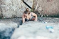 Young slender climber climbs a rock Royalty Free Stock Photo