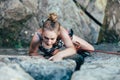 Young slender climber climbs a rock Royalty Free Stock Photo