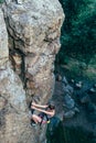 Young slender climber climbs a rock Royalty Free Stock Photo