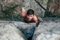 Young slender climber climbs a rock Royalty Free Stock Photo