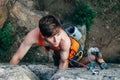 Young slender climber climbs a rock Royalty Free Stock Photo