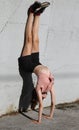 slender girl doing exercises sitting on the wall with legs in the air Royalty Free Stock Photo