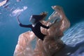 Young Slender Girl Underwater with a Cloth. Water Magic. Underwater Photography. Art Royalty Free Stock Photo