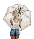 A young, slender, tanned girl in a t-shirt and shorts stands under a transparent umbrella