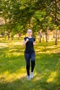 Young, slender woman doing jogging on the spot. Sports activities in the summer park Royalty Free Stock Photo