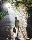 Young slim asian woman walking in beautiful morning sun rays Royalty Free Stock Photo