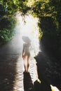 Young slim asian woman walking in beautiful morning sun rays Royalty Free Stock Photo