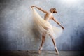 Young ballerina in a golden colored dancing costume is posing in a loft studio Royalty Free Stock Photo