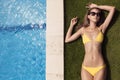 Young slim beautiful woman in yellow bikini sunbathing Royalty Free Stock Photo