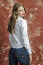 Young slim beautiful young blond woman with long legs and hair in Bedlam shirt and jeans Royalty Free Stock Photo