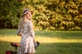 Young, slim, blonde woman on bicycle against defocused park landscape. Autumn color shade