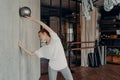 Slender redhead woman exercising with mini pilates ball in ballet studio Royalty Free Stock Photo