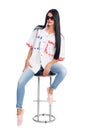 Young slim elegant woman sitting on a chair