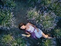 Young slim fair-skinned girl brunette beautiful lies in lavender field