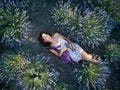 Young slim fair-skinned girl brunette beautiful lies in lavender field