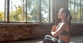 Young slim girl meditate in hatha yoga anjali mudra easy pose healthy lifestyle. Royalty Free Stock Photo