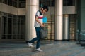 Young slim lad is standing on the street with a book Royalty Free Stock Photo