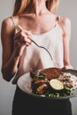 Woman is eating her lunch of fresh baked fish Royalty Free Stock Photo