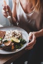 Woman is eating her lunch of fresh baked fish Royalty Free Stock Photo