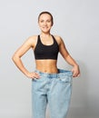 Young slim sporty woman in oversize pants