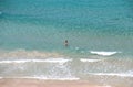 Young slim woman in blue sea. Top view turquoise transparent water