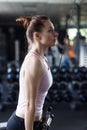 Young slim woman doing pushdown on cable machine in gym Royalty Free Stock Photo