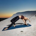 Young slim woman doing wild thing yoga pose on the mat outdoors at sunset Royalty Free Stock Photo