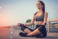 Young slim woman doing yoga exercises outdoors on the bridge. Royalty Free Stock Photo