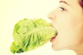 Young slim woman eating lettuce. Royalty Free Stock Photo