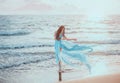 Young, slim woman with long legs dancing on the ocean Royalty Free Stock Photo