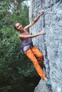 Young slim woman rock climber climbing on the cliff Royalty Free Stock Photo