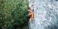 Young slim woman rock climber climbing on the cliff Royalty Free Stock Photo