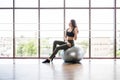 Young slim Woman in sportswear exercising her abs on a Pilates ball of fitball close up at gym. Fitness concept Royalty Free Stock Photo