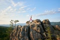 Young slim woman standing with raised hands in yoga pose on top of rocky mountain Royalty Free Stock Photo