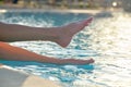 Young slim woman& x27;s legs relaxing near swimming pool in summer sun. Tropical vacation concept Royalty Free Stock Photo